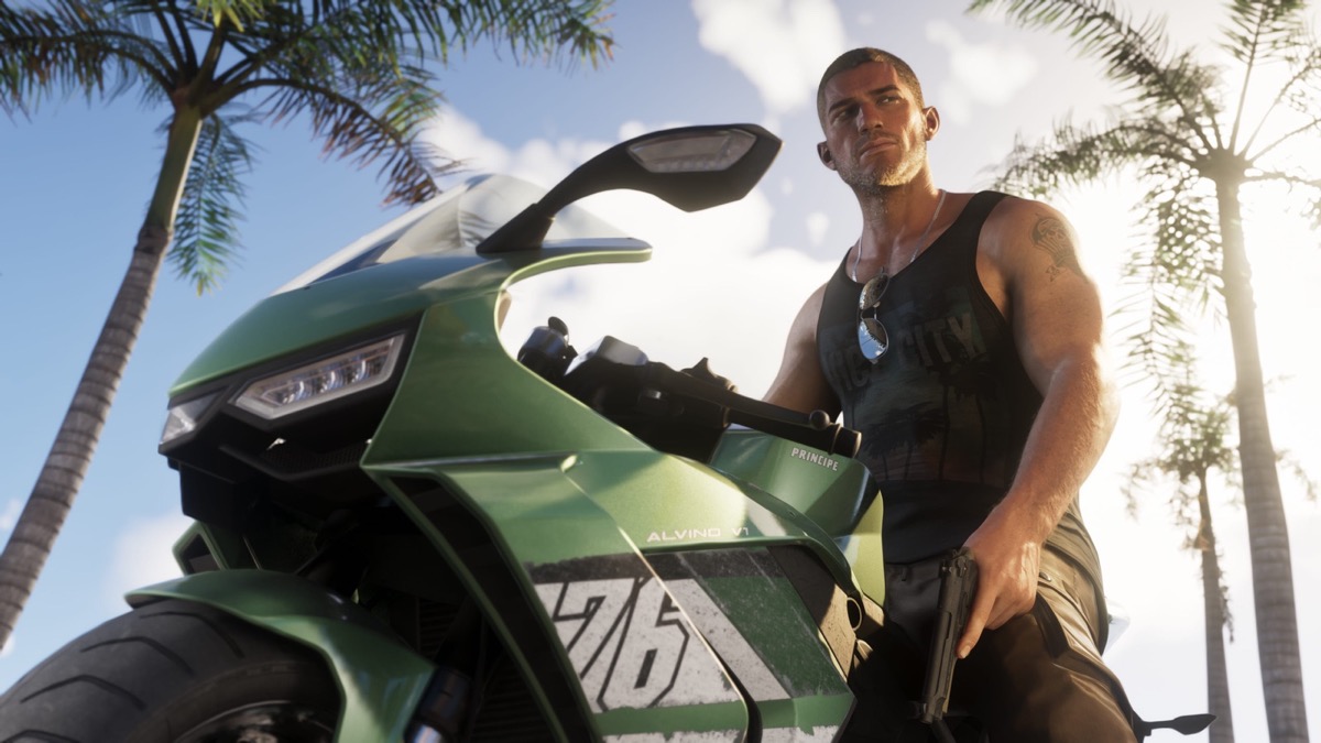 Jason Duval beside a motorcycle under palms